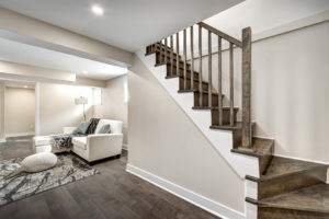 a finished basement with stairs and couch